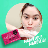 A woman is holding a marvelous AHA Mandelic Face and Body Soap by S-SKIN by Snoe, showcasing its beauty and skincare benefits.