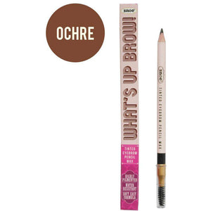 The image features a beauty must-have: an eyebrow pencil along with its packaging. Labeled "Snoe," this dual-ended makeup tool includes a brush. The box prominently displays the bold "WHATS UP BROW!" text, spotlighting the product named "Tinted Eyebrow Pencil Wax In OCHRE." The shade, Ochre, is a brown tone shown in a swatch circle.