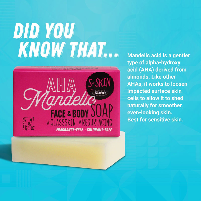 The image features a bar of AHA Mandelic Face and Body Soap, highlighting its packaging. The pink label prominently displays "S-SKIN by Snoe" alongside the attributes "Fragrance-Free • Colorant-Free," making it an excellent choice for beauty enthusiasts with sensitive skin. A light blue backdrop outlines the benefits of mandelic acid, ideal for pre-makeup preparation.