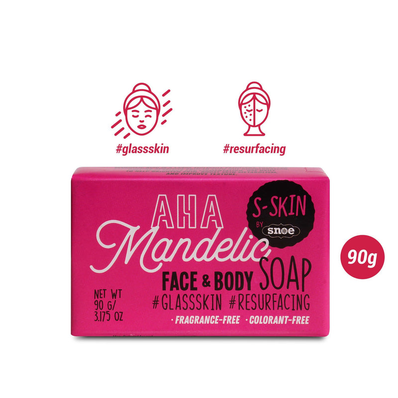 The image displays a pink box with the label "AHA Mandelic Face and Body Soap #glassskin #resurfacing" from S-SKIN by Snoe, ideal for beauty enthusiasts aiming for "glass skin" and resurfacing effects. This 90g soap is free from fragrances and colorants. Red icons emphasize its skincare and exfoliation features, making it a vital part of your routine.