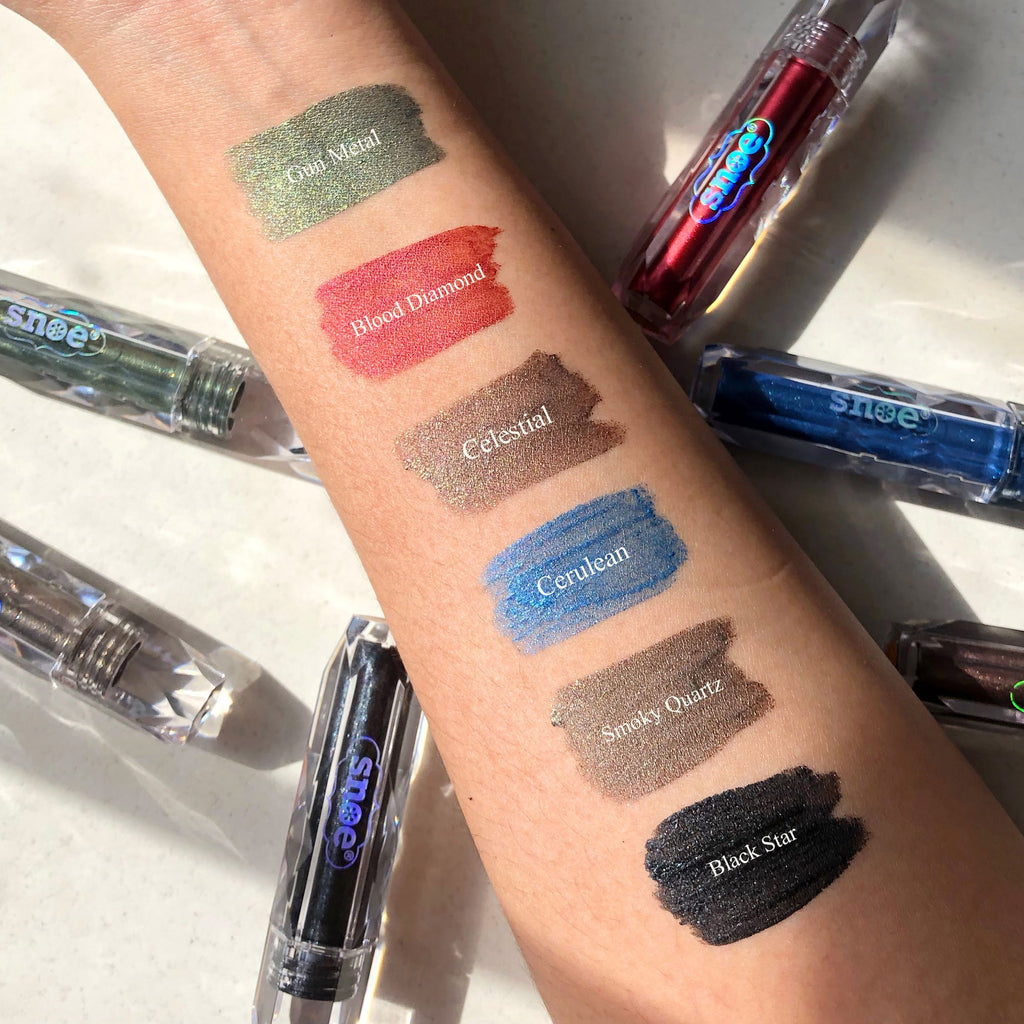 Swatches of BLING BLING Glitter Liquid Eyeshadow in CELESTIAL on a woman's arm.