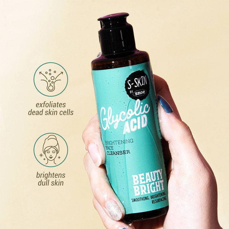 A hand holds a teal bottle of GLYCOLIC ACID BRIGHTENING FACE CLEANSER by S-SKIN from Snoe. The label says "Beauty Bright," with promises of smoothing, brightening, and resurfacing effects. Icons on the left show exfoliation of dead skin cells and the brightening of dull skin, enhancing your beauty routine against a light beige background.