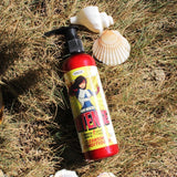 A bottle of Intense Cleansing Conditioner by HAIR HEROES enhancing beauty sitting on the grass.