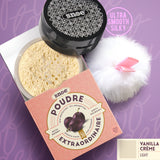 The Loose Powder SPF 30+ in VANILLA CREME by POUDRE EXTRAORDINAIRE is next to a beauty pom pom.